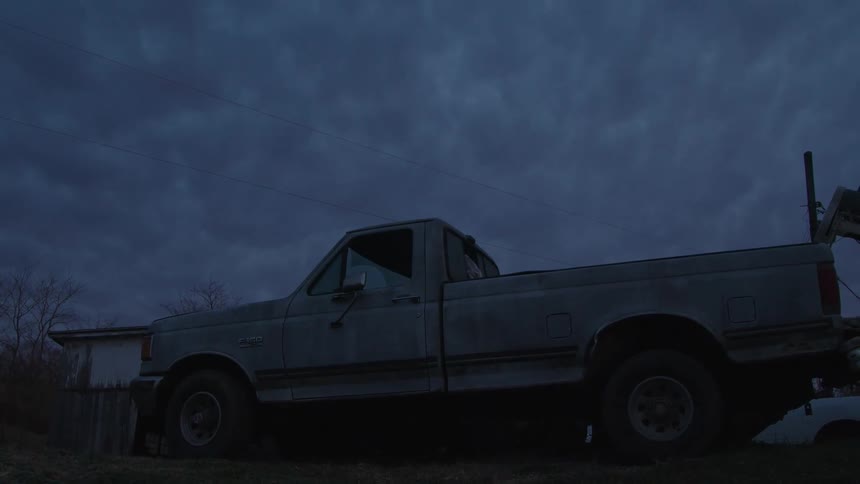 A truck is parked in front of the structure