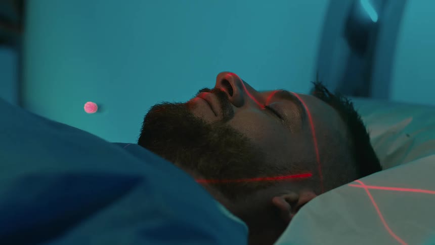 A patient undergoing an examination while sleeping in bed