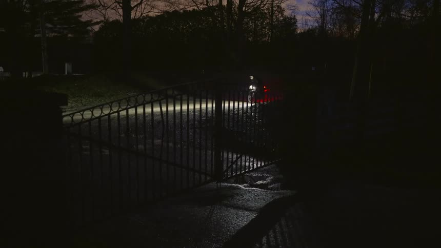 A person riding a bicycle around the neighborhood at night