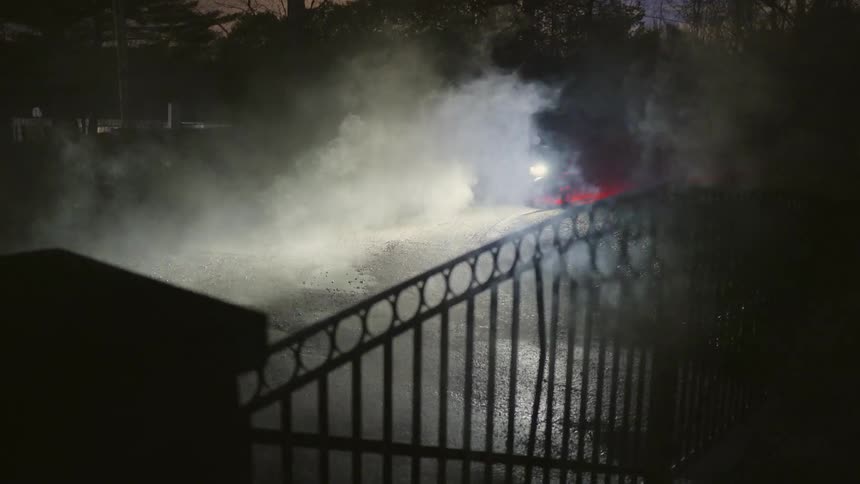 Person riding a bicycle at high speed on a dark and foggy street