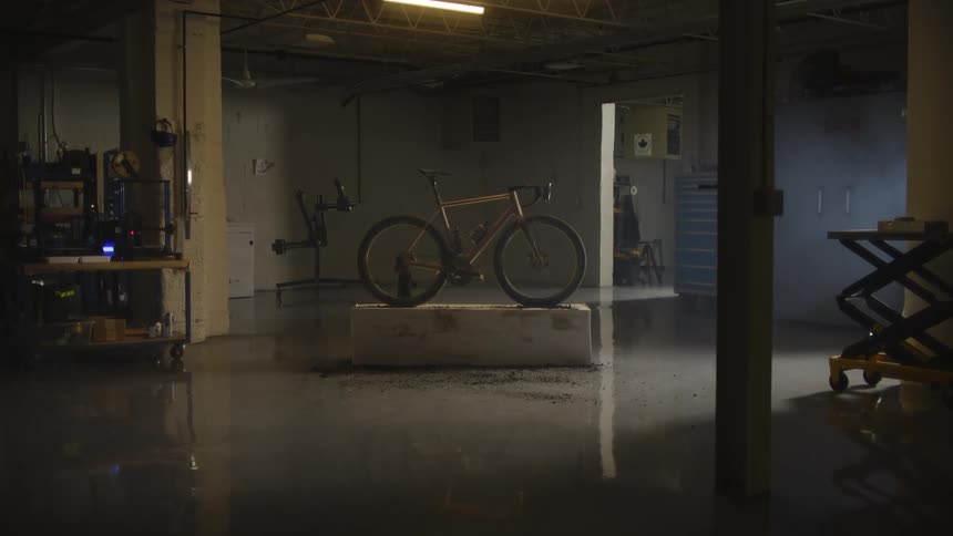 Bicycle inside a dark room with machinery
