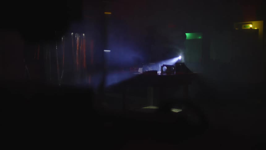 Thief entering a dark establishment with a flashlight