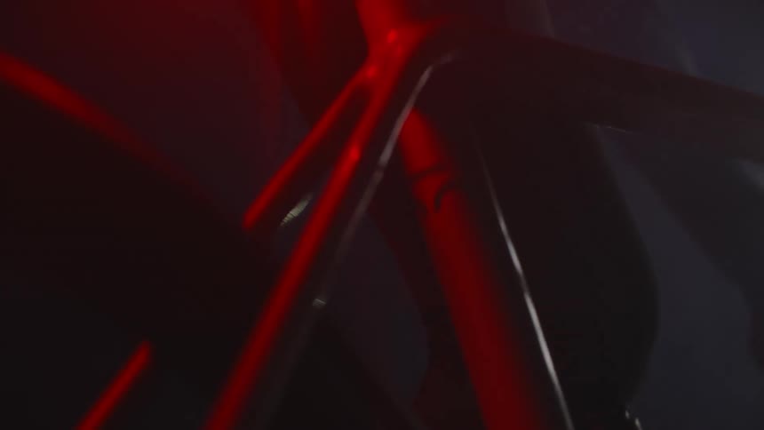 Close up of the metal frame of a bicycle riding at night