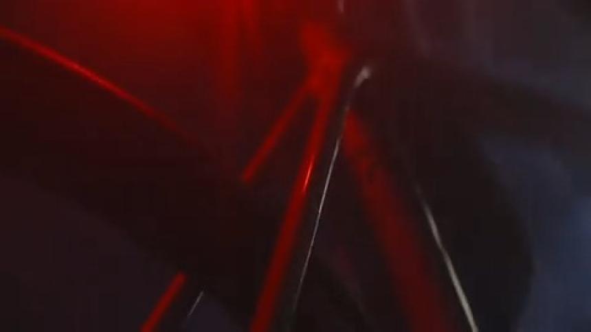 Closeup of a persons legs pedaling a bicycle at night