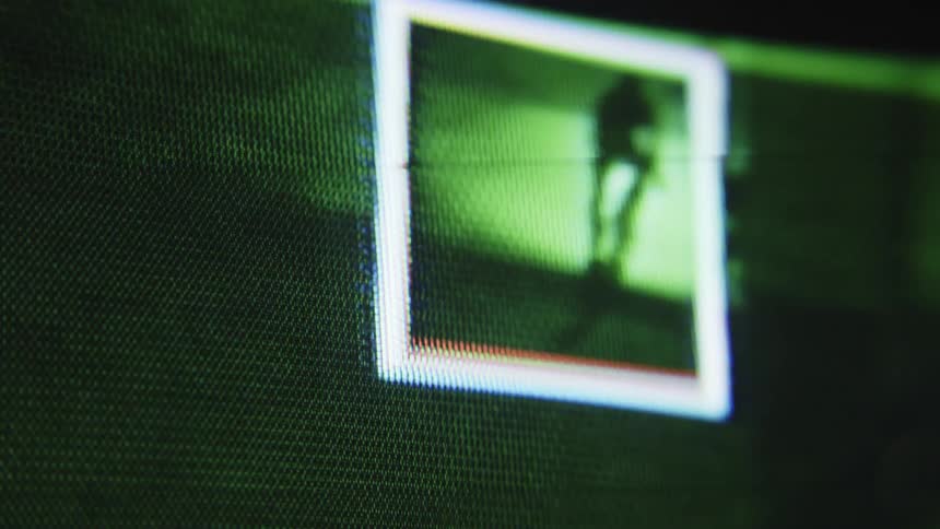 Close up of a screen following a cyclist at night