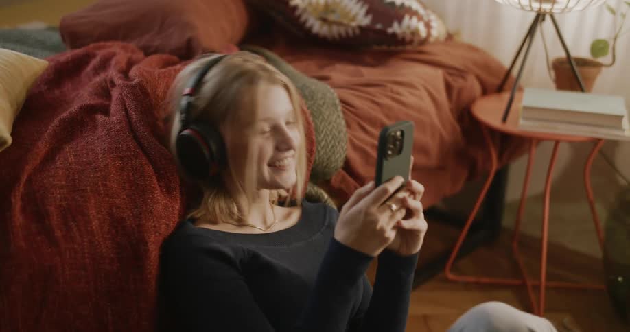 A girl laughs while using her cell phone