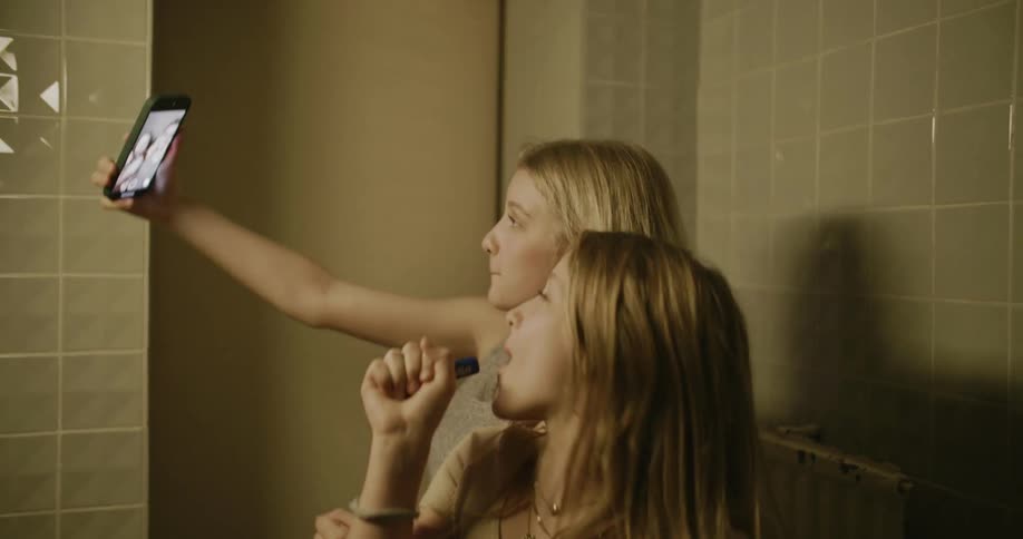 Two girls dancing and singing in the bathroom