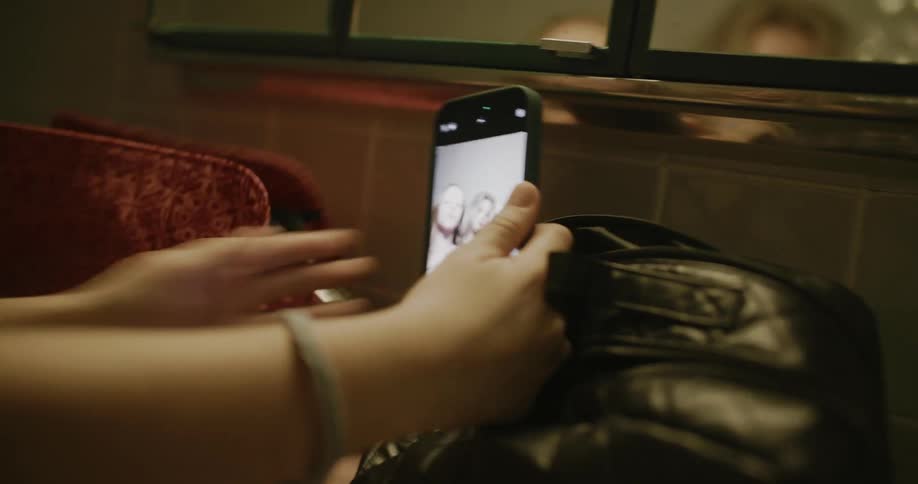 Two people taking selfies on a smartphone