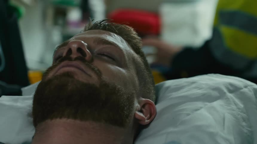Patient with open chest with equipment monitoring him as he sleeps on a machine inside an outpatient clinic