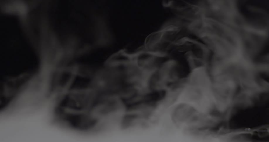 Smoke vapors rise and curl against a black backdrop