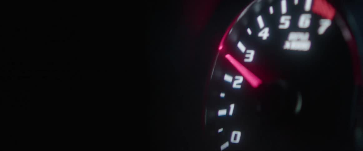 Closeup of a vehicles odometer with the power settings raising the pointer