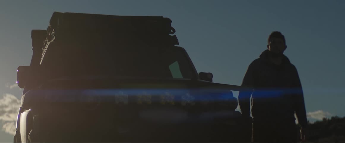 A man gets out of a car and walks off