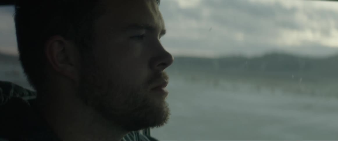 Face of a man inside a moving car at sunset