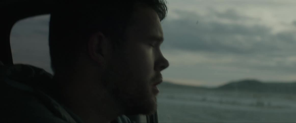 Portrait of a concentrated man making a turn inside the car in the middle of a desert place