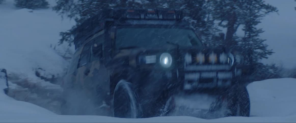Sports van passing by a lake and snow in a forest