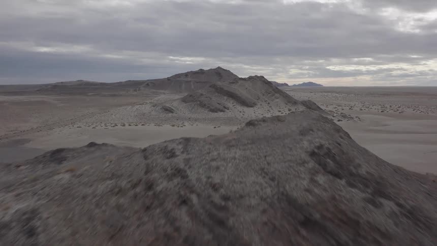 Aerial panorama of ruins in the middle of a desert soil on a cloudy morning