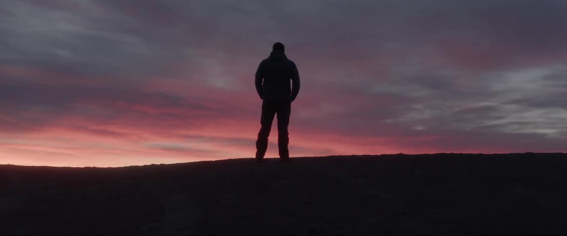 A clip of a person standing and looking afar