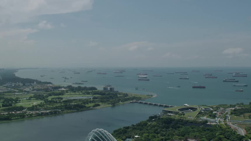Aerial panorama of a sea water dam with boats and a city