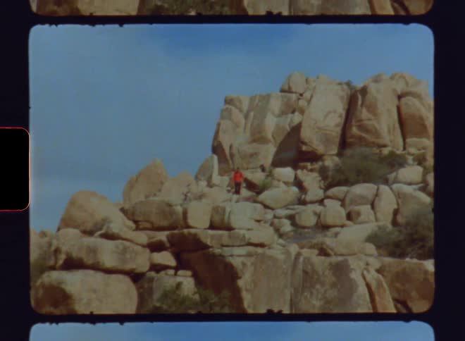 Two men climb a rocky mountain