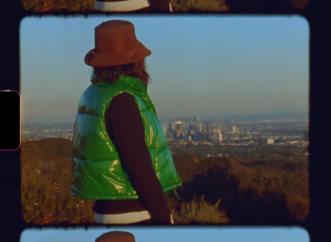 Woman on a hill with a panoramic view of a metropolitan city