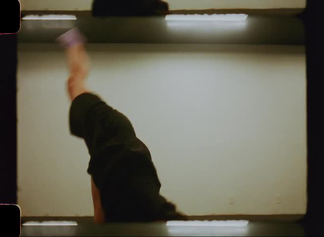A young woman dances frenetically