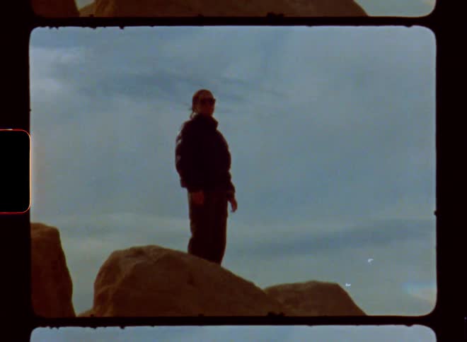 A clip of a lady standing on rocks