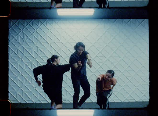 Three women in a studio dancing a joint choreography