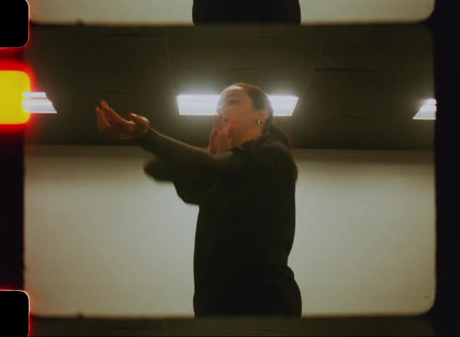 Woman inside a studio ejaculating her arms and dancing