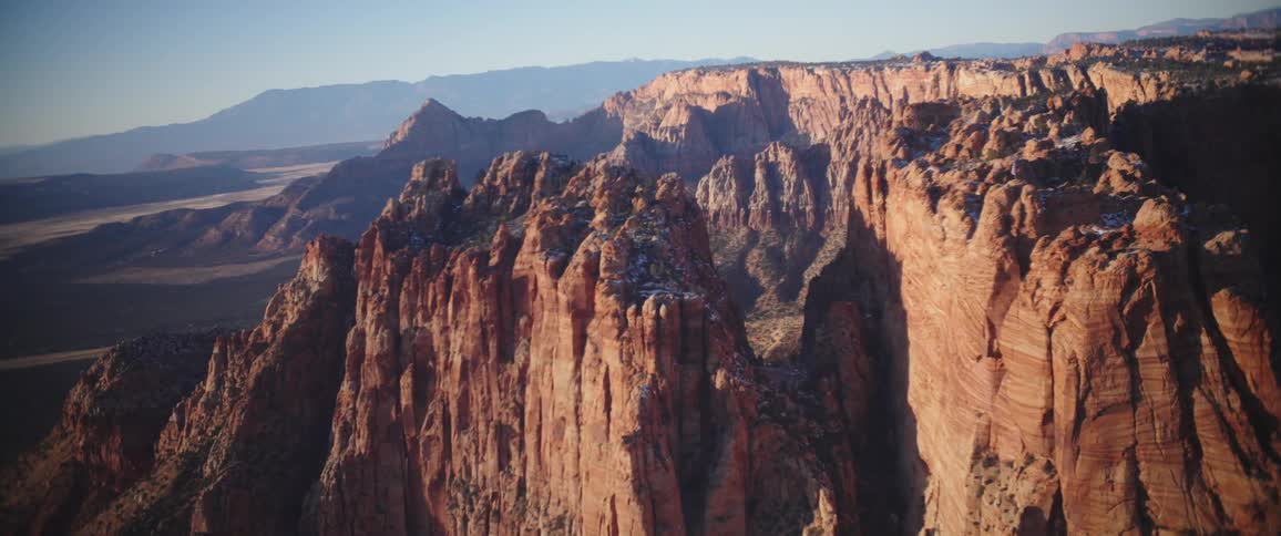Aerial panorama of mountain ranges with cliffs and rock and geological formations