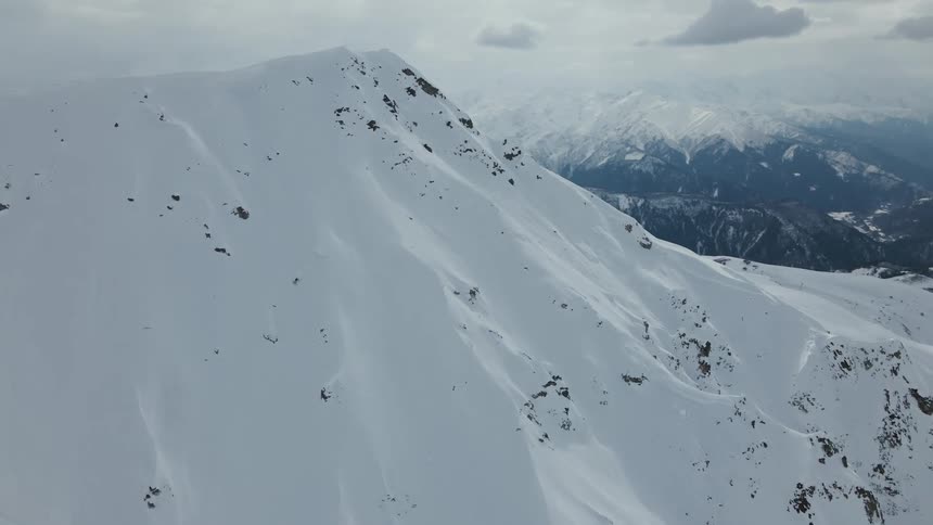 Person skiing on a mountain covered in snow on a sunny day