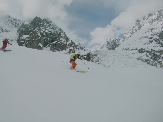 People skiing on a snowy day near the mountain