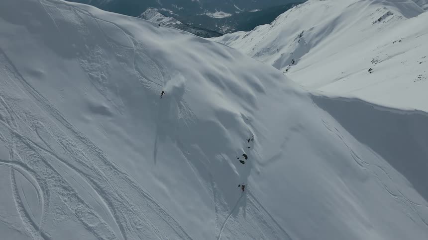 A person ski down a snow covered slope in the mountain
