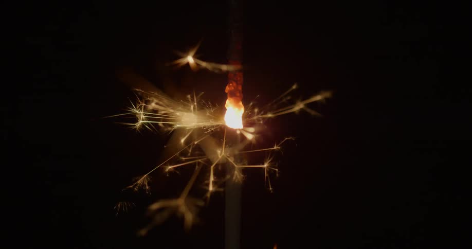 A lit sparkler burns