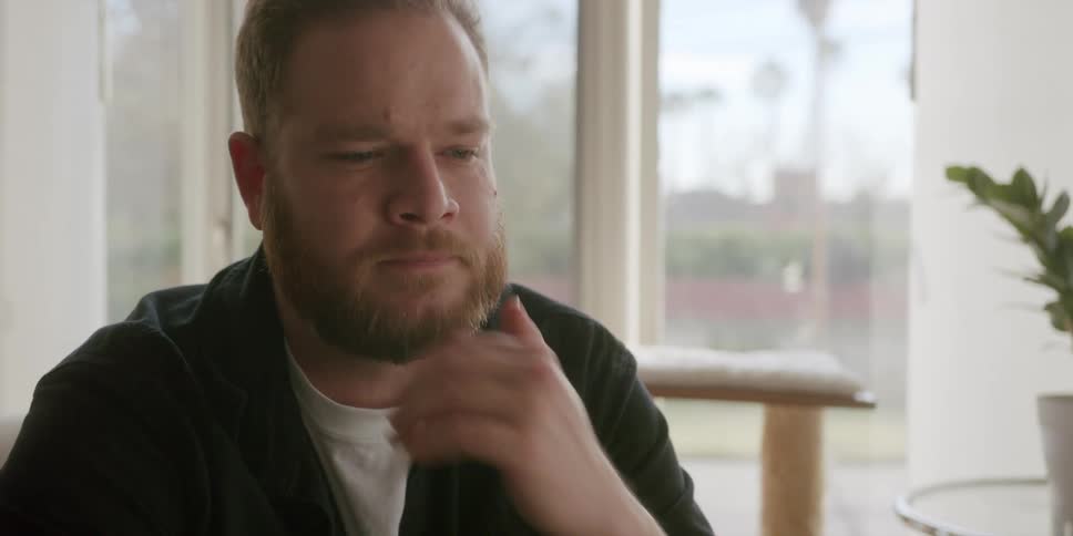 A man sitting in a room thinking about something