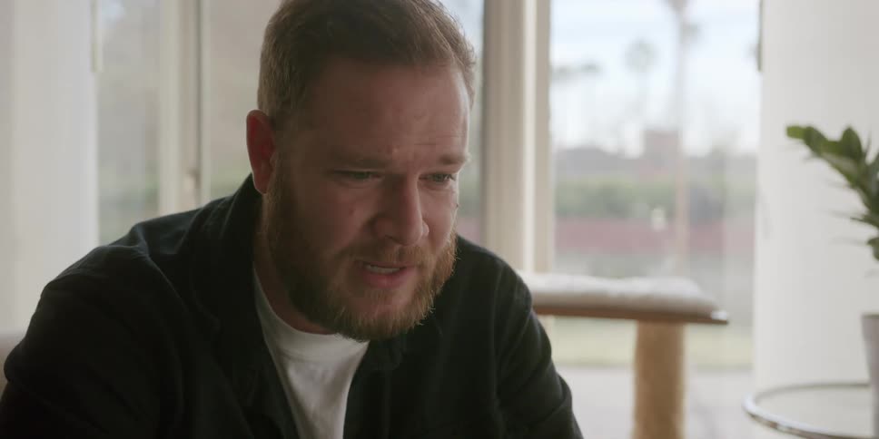Portrait of a man sitting indoors talking