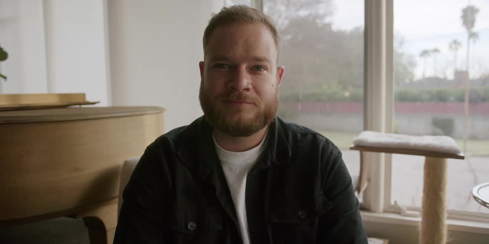 A man sitting smiling in the room