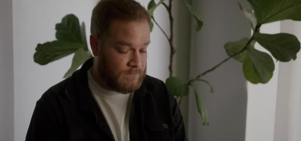 A man is looking around the room