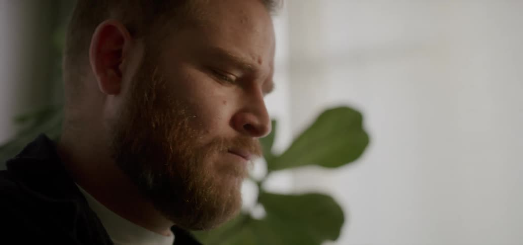 A sad looking man makes faces and nods