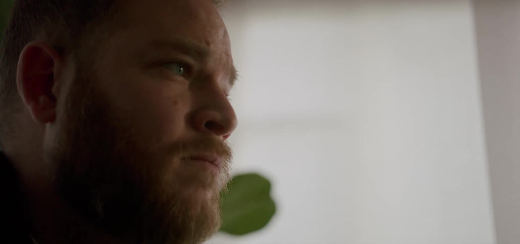 Portrait of a bearded man with a neutral facial expression