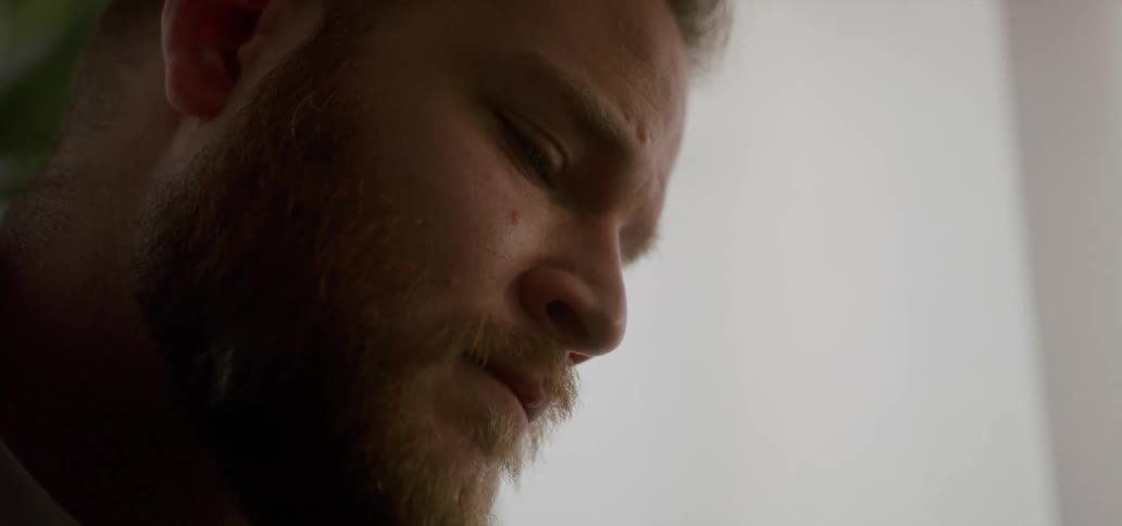 Side portrait of a man with a beard with neutral facial expression