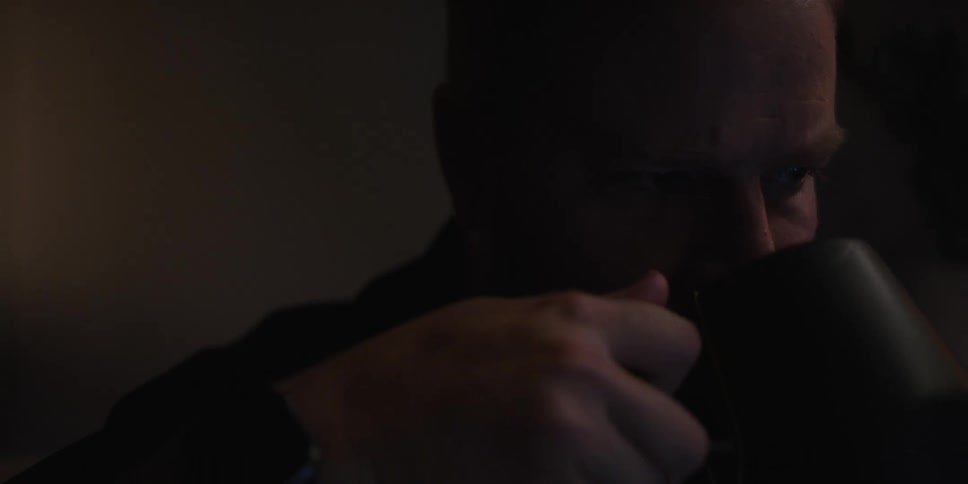 A man drinks from his mug