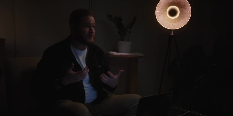 A man uses extensive hand gestures while speaking