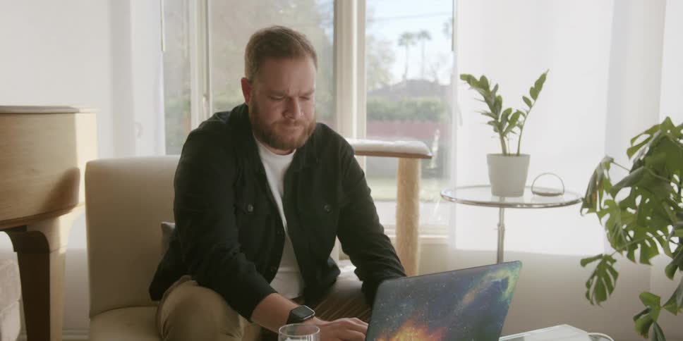 A man is typing on his laptop