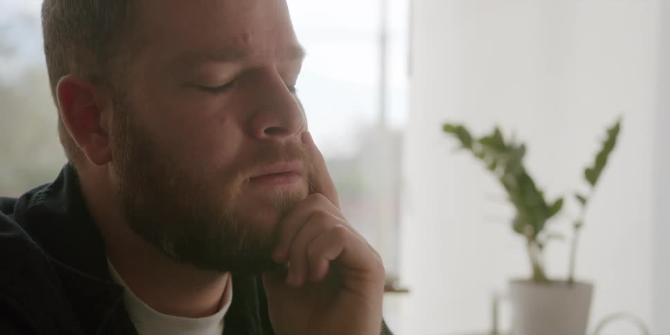 A man sitting in a room thinking