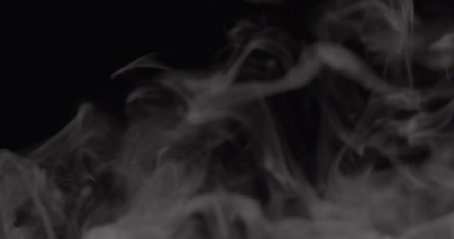 Smoke flowing in the air in darkness