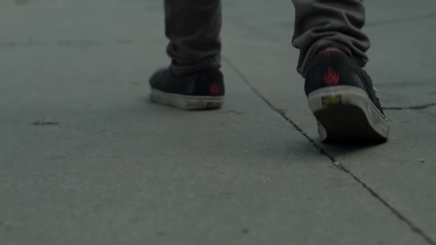 A man walks down a sidewalk