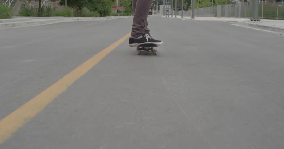 A skateboarder rides down the street