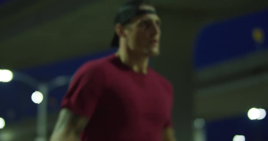 Man parallels overpass while running at night