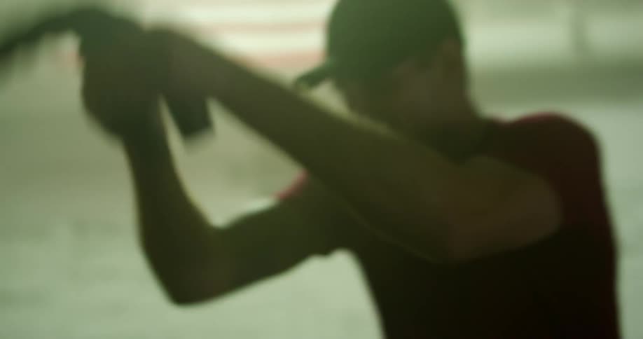 A man does strength exercises with thick rope