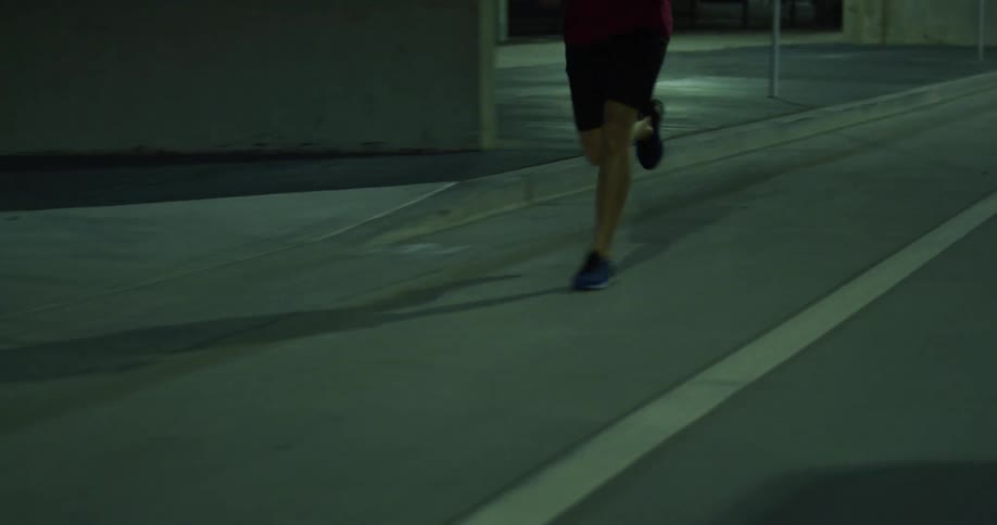 Man running through city streets at night
